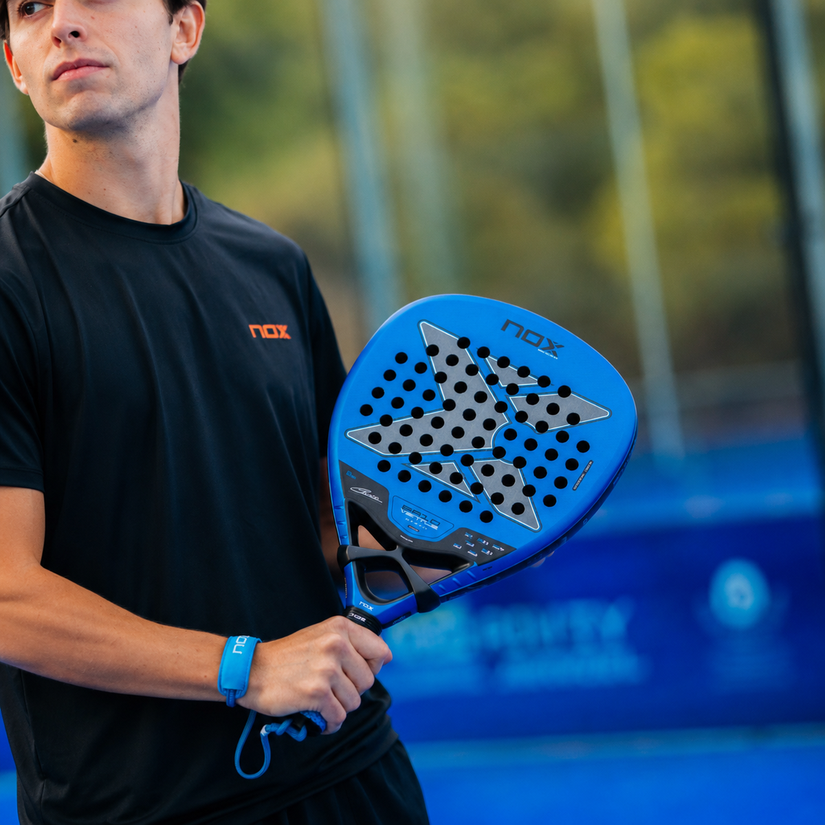 Padel player holding a NOX racket